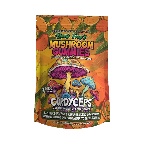 The image shows a product packaging design for "Uncle Frog's MUSHROOM GUMMIES," which are described as being infused with "Earth's finest hemp." The packaging is vibrant and colorful, with illustrations of various mushrooms, including a prominent one with a blue cap and pinkish underside at the center. Below the mushrooms, there is a bold text that reads "CORDYCEPS" followed by "NATURAL ENERGY AND POWER," indicating the type of mushrooms or the intended effect of the gummies. Additional text explains that the product includes a "natural blend of cordyceps mushroom and broad spectrum hemp to elevate your day." At the bottom, it is noted that the package contains "8 mango flavored gummies (1 oz)." The design is very much in the style of psychedelic artwork, with rich colors and a busy, illustrative style that suggests a natural, energetic experience.