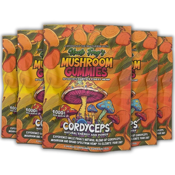 Five packages of "Uncle Frog's Mushroom Gummies" with vibrant, colorful packaging featuring illustrations of mushrooms and a tropical theme. The text highlights "CORDYCEPS," "Natural Energy and Power," and "Experience the Multiverse with Earth's Finest Hemp," suggesting health and vitality benefits. The gummies are mango-flavored and boast a "1000 mg Active PER SERVE" designation, emphasizing their potency.