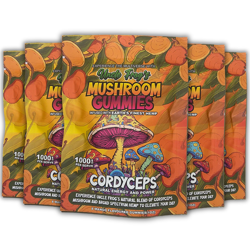 Five packages of "Uncle Frog's Mushroom Gummies" with vibrant, colorful packaging featuring illustrations of mushrooms and a tropical theme. The text highlights "CORDYCEPS," "Natural Energy and Power," and "Experience the Multiverse with Earth's Finest Hemp," suggesting health and vitality benefits. The gummies are mango-flavored and boast a "1000 mg Active PER SERVE" designation, emphasizing their potency.